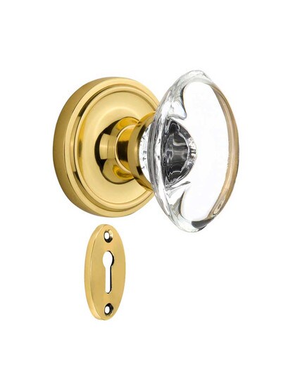 Classic Rosette Mortise-Lock Set with Oval Crystal Glass Knobs in Polished Brass.